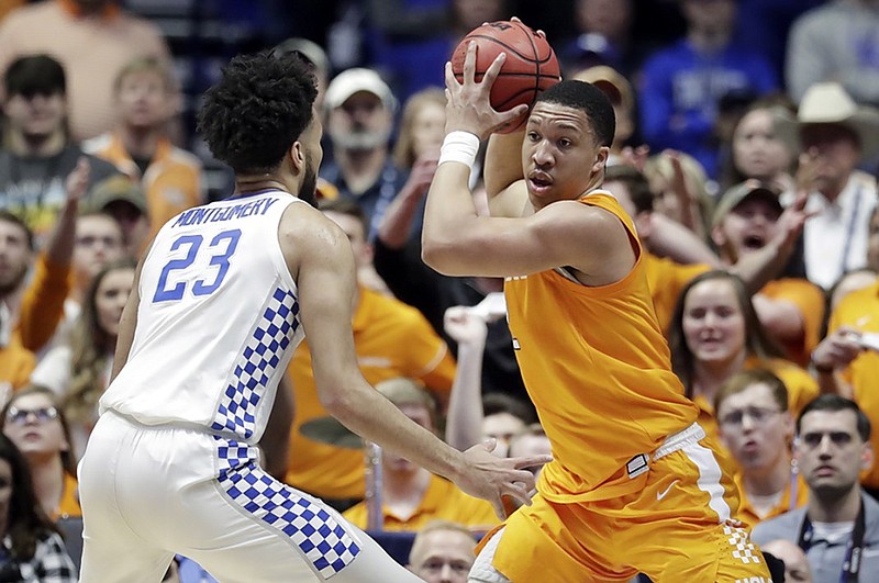 Kentucky forward E.J. Montgomery guards Tennessee's Grant Williams during an SEC men's basketball tournament semifinal Saturday at Bridgestone Arena in Nashville.