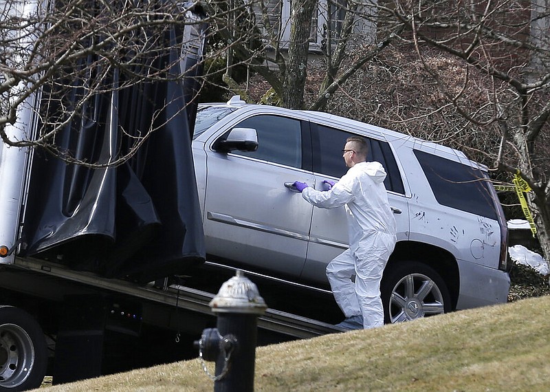 Crime scene investigators load a car that appears to have been checked for fingerprints onto a flatbed truck in the Staten Island borough of New York, Thursday, March 14, 2019. Francesco "Franky Boy" Cali was found with multiple gunshot wounds at his red-brick colonial-style house on Staten Island on Wednesday night and was pronounced dead at a hospital. 