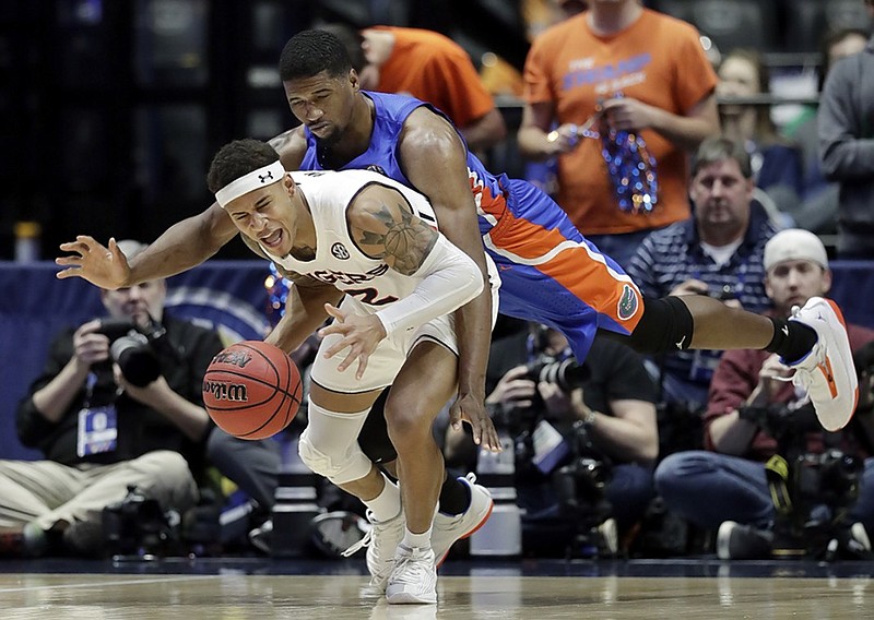 Auburn guard Bryce Brown, front, is fouled by Florida center Kevarrius Hayes during the second half of their SEC men's basketball tournament semifinal Saturday in Nashville. Auburn won 65-62.