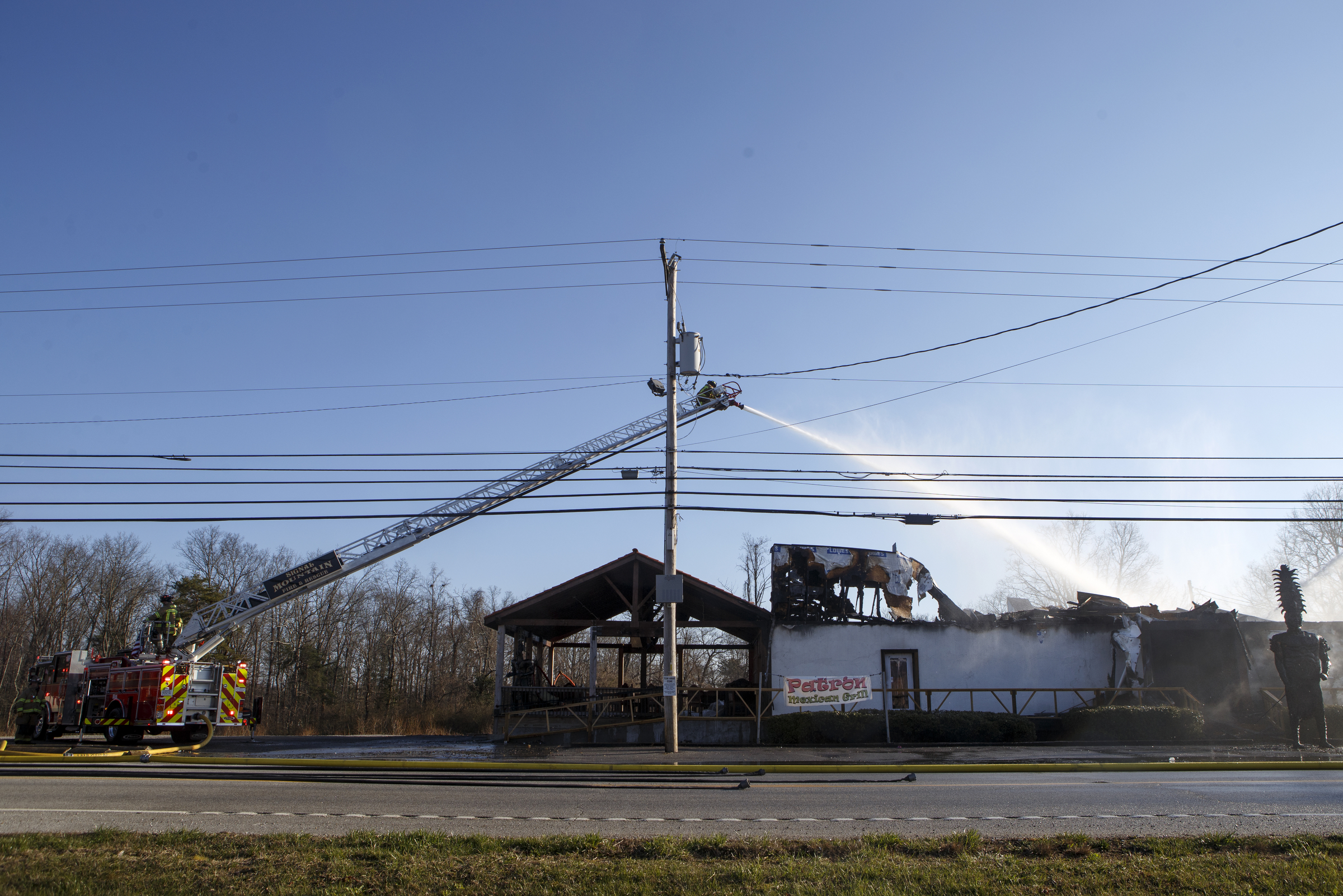 A ladder truck works to put out a fire at Patron Mexican Grill located at 3720 Taft Highway on Monday, March 18, 2019 in Signal Mountain, Tenn.