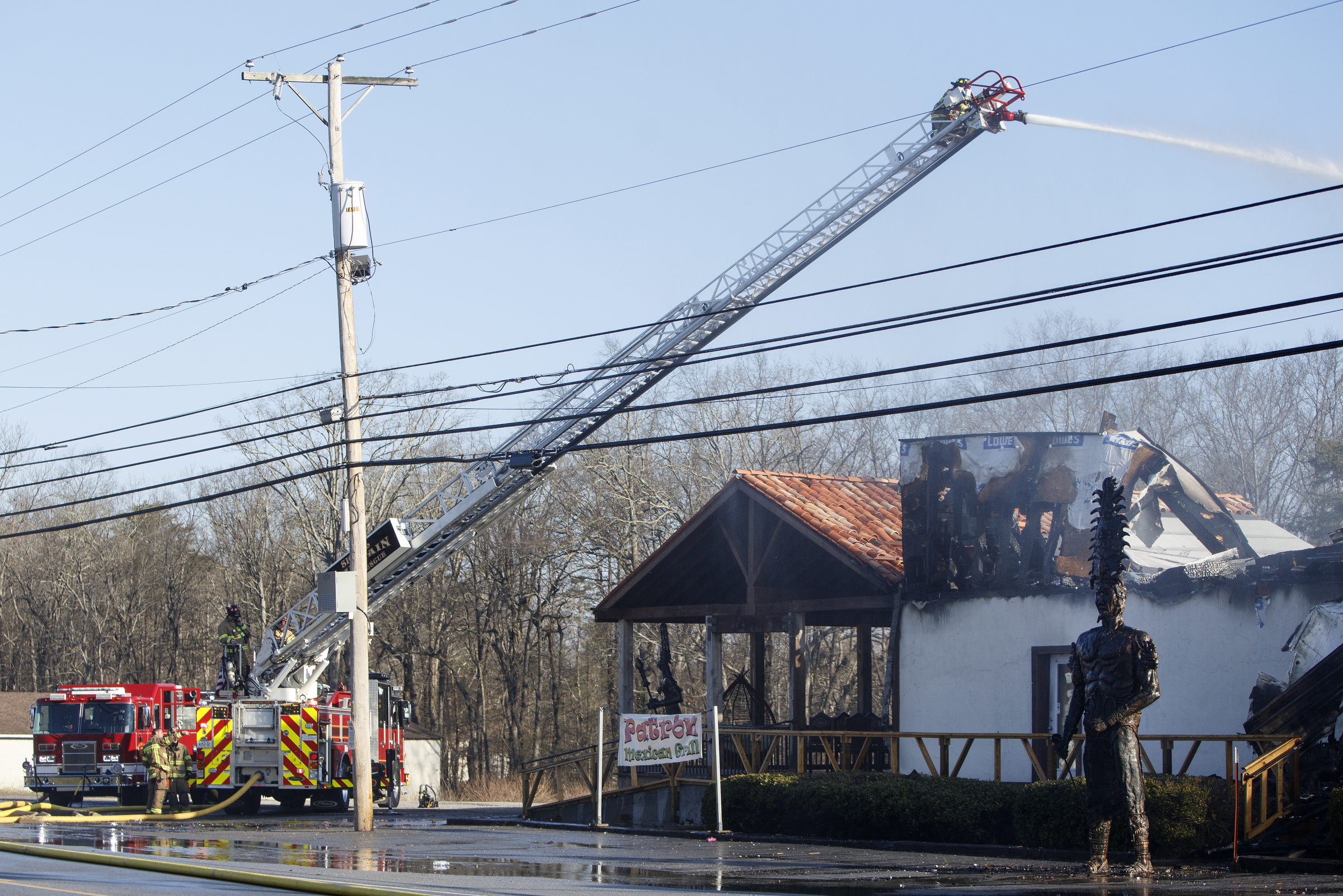 A ladder truck works to put out a fire at Patron Mexican Grill located at 3720 Taft Highway on Monday, March 18, 2019 in Signal Mountain, Tenn.