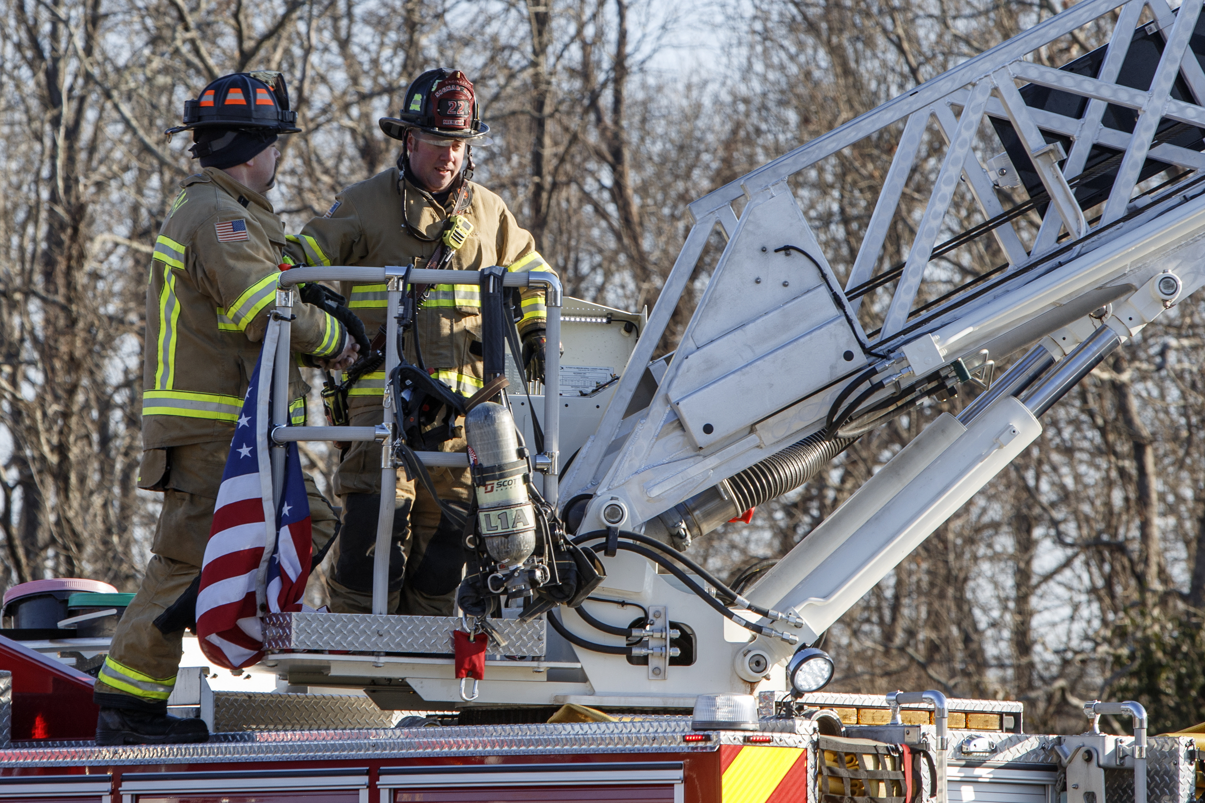 Firefighters stand on the back of a truck while working a fire at Patron Mexican Grill located at 3720 Taft Highway on Monday, March 18, 2019 in Signal Mountain, Tenn.