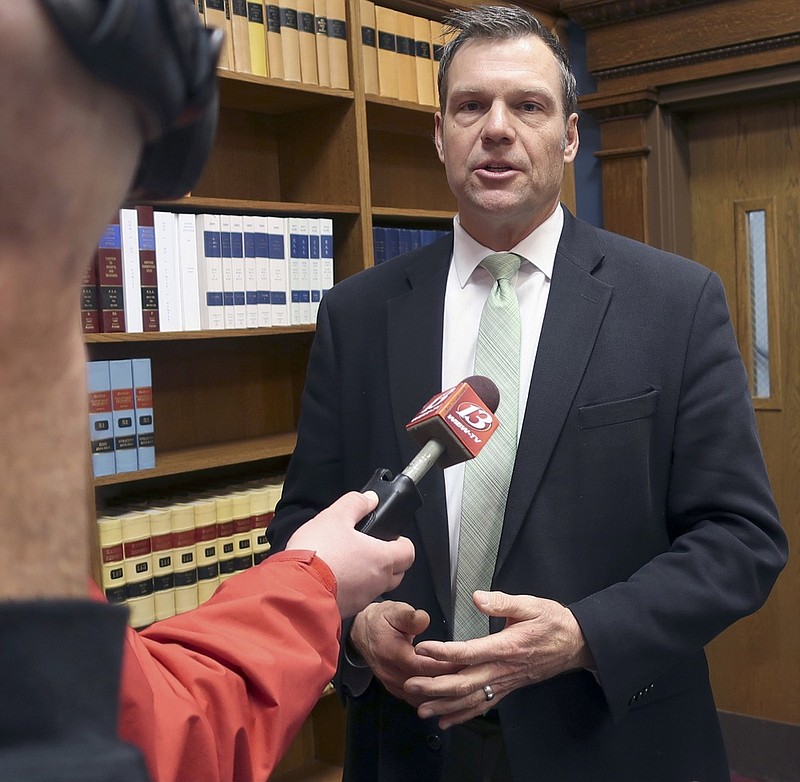 FILE - In this Nov. 30, 2018 file photo, then Kansas Secretary of State Kris Kobach responds to questions from reporters in Topeka, Kan. An appeals court in Salt Lake City, will consider Monday, March 18, 2019, the constitutionality of a struck down Kansas statute that had required people to provide documents proving U.S. citizenship before they could register to vote. (AP Photo/John Hanna, File)

