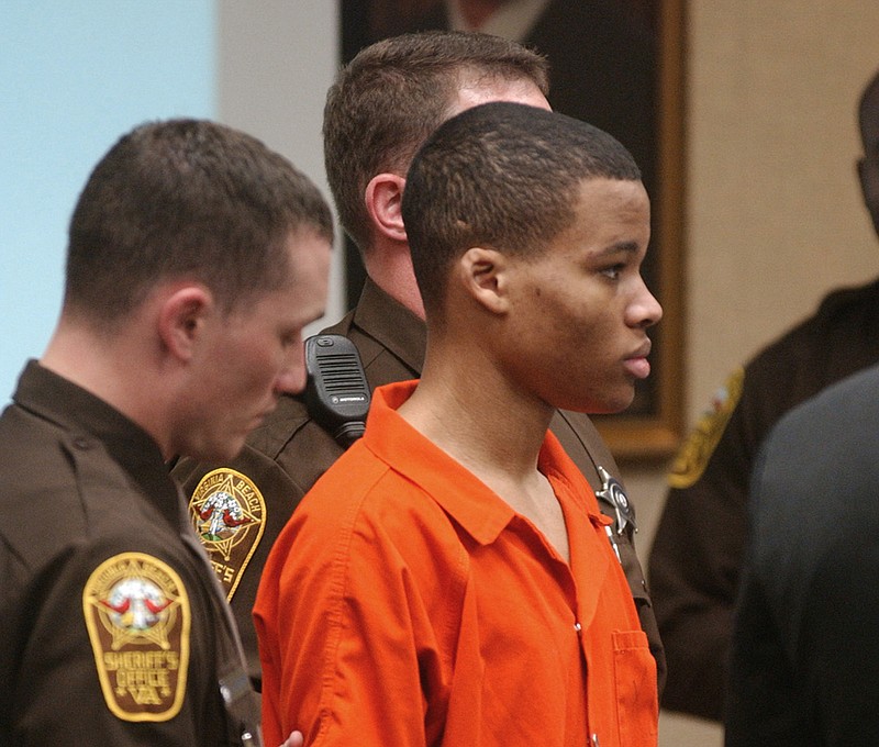 FILE - In this Oct. 20, 2003 file photo, Lee Boyd Malvo listens to court proceedings during the trial of fellow sniper suspect John Allen Muhammad in Virginia Beach, Va. The Supreme Court has agreed to consider Virginia's plea to reinstate the life without parole sentence of a man who participated in sniper shootings that terrorized the Washington, D.C., region in 2002. The justices said Monday they will take up the state's appeal in the case of Lee Boyd Malvo. Malvo was 17 when he and John Allen Muhammad fatally shot 10 people in Maryland, Virginia and Washington. Malvo was sentenced to life-without-parole terms in both Virginia and in Maryland. (AP Photo/Martin Smith-Rodden, Pool, File)

