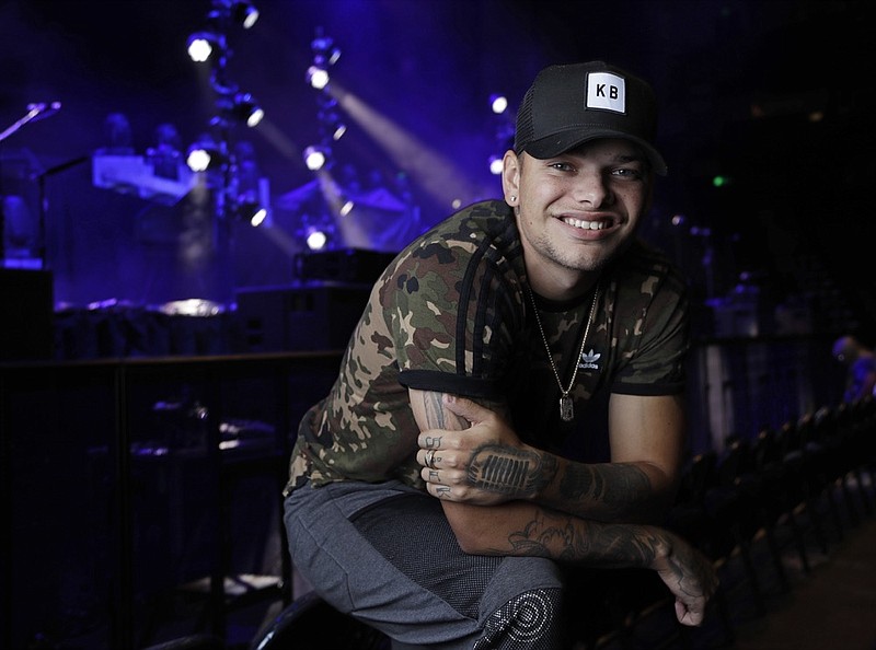FILE - In this Sept. 22, 2018, file photo, country singer Kane Brown poses in Nashville, Tenn. Brown and producer Polow Da Don are suing each other over a contract dispute that has both sides claiming they are owed money. The producer claimed Brown breached his initial contract and asked for damages in a Feb. 2019 lawsuit. Brown's attorneys filed a countersuit Monday, March 18, 2019, claiming that Brown was misled about the agreement and that the contract is fraudulent. (AP Photo/Mark Humphrey, File)

