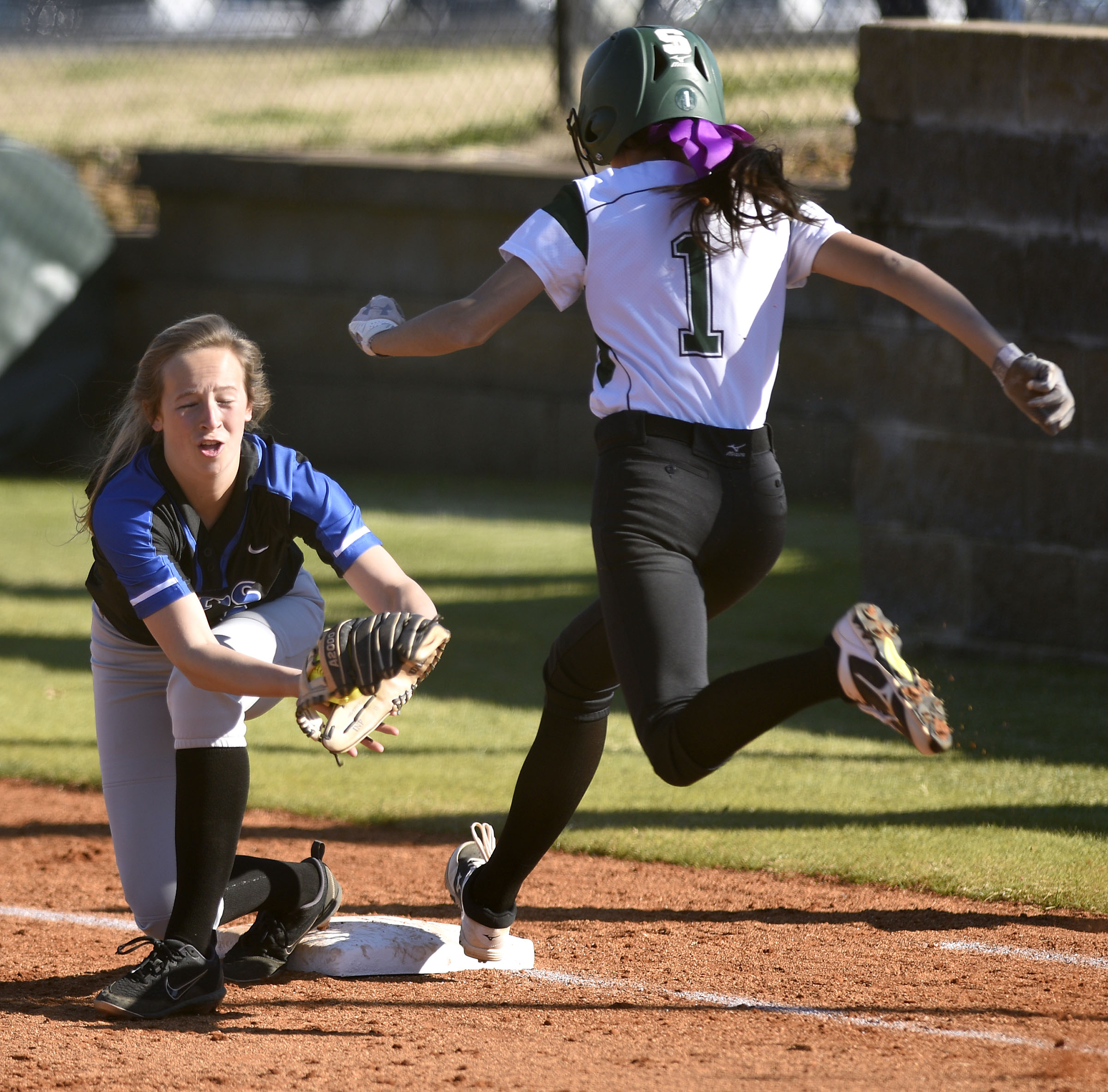 GPS second baseman Chapel Cunningham (9) covers first on Silverdale's Bentlee Stiner (1) bunt. Stiner was out, but did advance the runners. The Silverdale Baptist Academy Lady Seahawks hosted the Girls Preparatory School Bruisers in TSSAA softball action on March 19, 2019.
