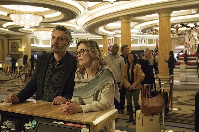 This image released by A24 shows John Torturro and Julianne Moore in a scene from "Gloria Bell." Everyone is vanishing around Julianne Moore's title character in Sebastian Lelio's "Gloria Bell." The disappearances don't come with blood-curdling shrieks or thundering score cues, but with the humdrum ebb of middle age. People just move away or recede from view. (A24 via AP)