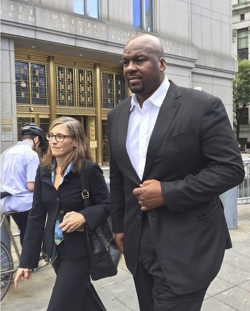 FILE -- In this Oct. 10, 2017 file photo, former Auburn University assistant men's basketball coach, Chuck Person, leaves Manhattan federal court in New York, after an initial appearance before a magistrate judge. Person is scheduled to plead guilty on Tuesday, March 19, 2019 to a conspiracy charge in a scandal that involved bribes paid to families of NBA-bound young athletes to steer them to top schools and favored money managers and agents. (AP Photo/Larry Neumeister, File)

