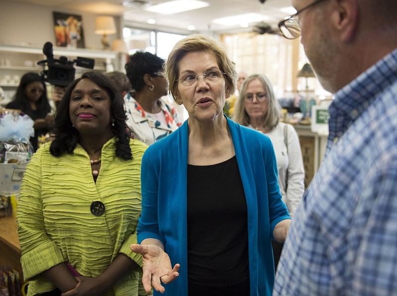 Democratic presidential candidate Sen. Elizabeth Warren, D-Mass., center, talks with owner Tim Williamson at Cater's Drug Store in Selma, Ala., on Tuesday, March 19, 2019. (Jake Crandall/The Montgomery Advertiser via AP)

