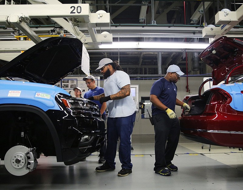 Volkswagen employees perform checks as vehicles move down the assembly line at the Volkswagen Assembly Plant Thursday, Aug. 31, 2017, in Chattanooga, Tenn. Each vehicle goes through variety of inspections before reaching the end of the assembly line.
