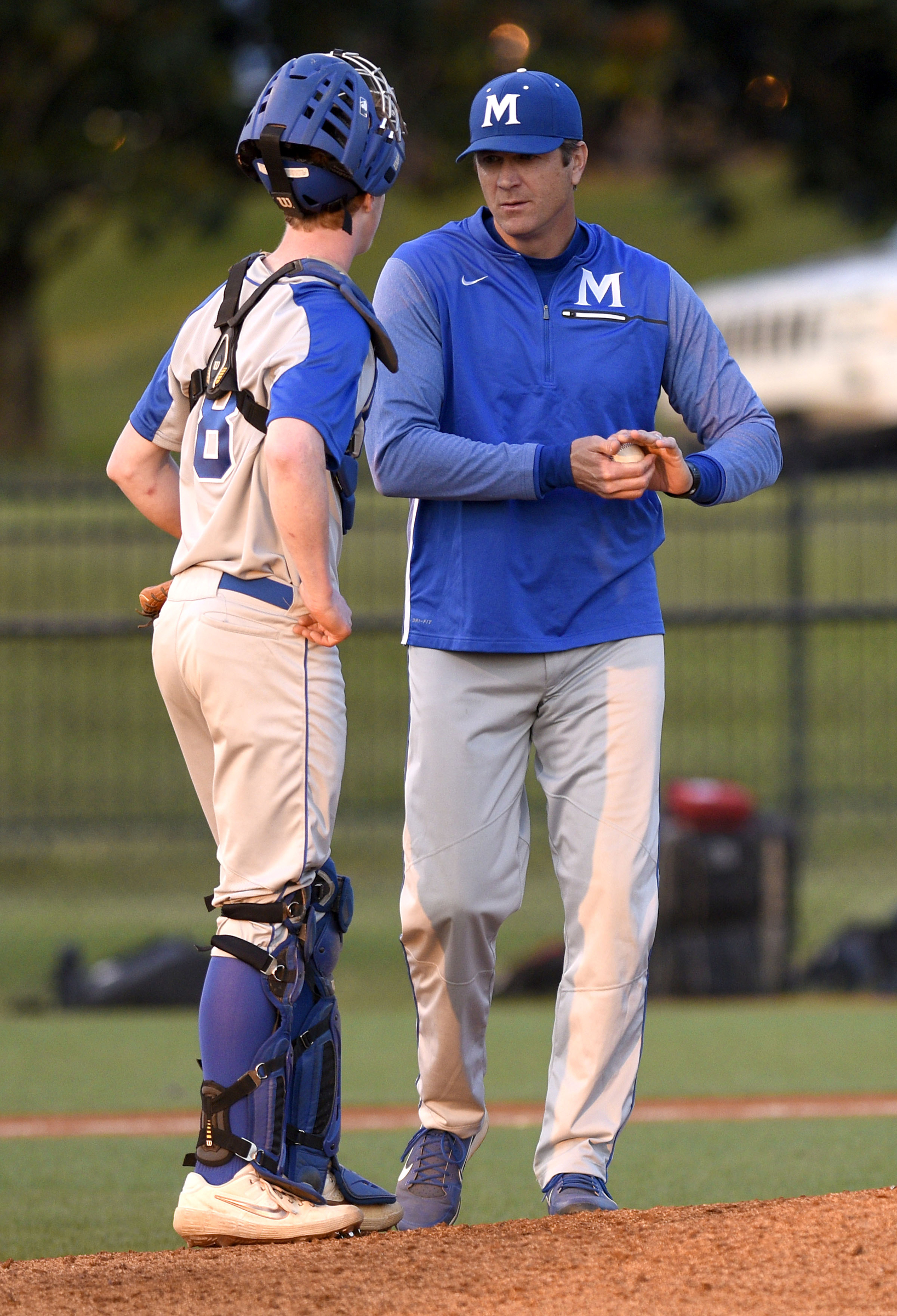 McCallie head coach Tim Costo talks to catcher Carter Edge (8) during a pitching change. The Baylor Red Raiders visited the McCallie Blue Tornado in TSSAA baseball action on March 20, 2019.