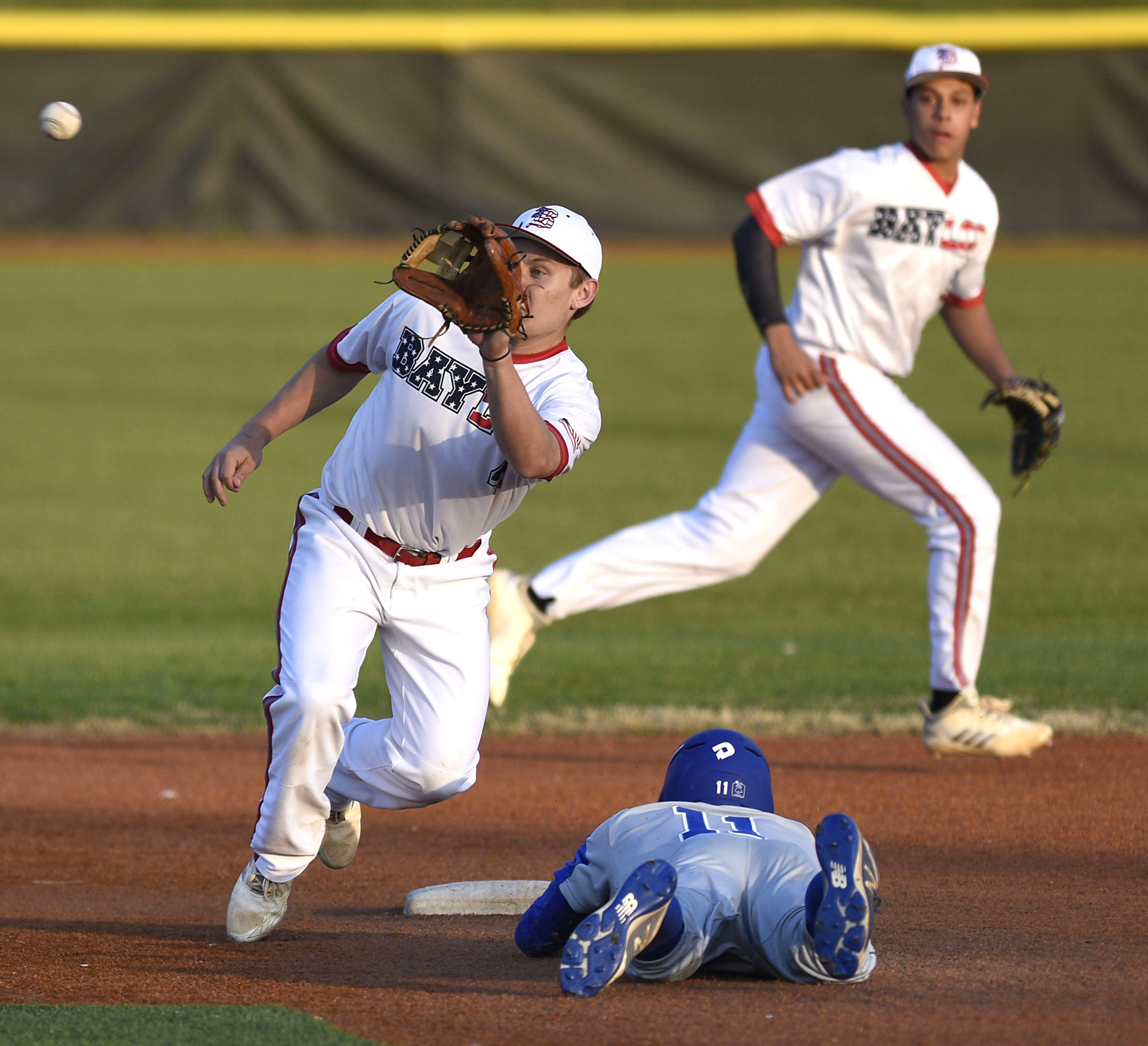 McCallie's Daulton Payne (11) steals second as Baylor second baseman Gehrig Ebel (4) takes the late throw. The Baylor Red Raiders visited the McCallie Blue Tornado in TSSAA baseball action on March 20, 2019.