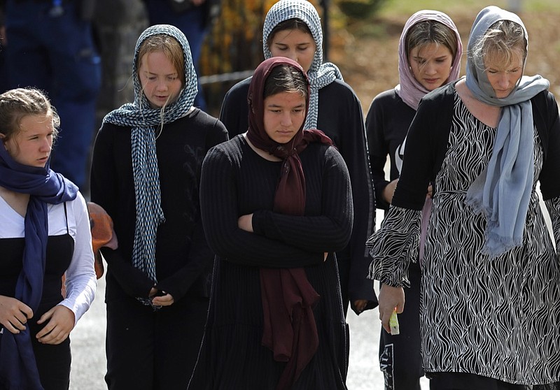 Mourners leave the cemetery after the burial service of the body of a victim of the Friday March 15 mosque shootings at the Memorial Park Cemetery in Christchurch, New Zealand, Thursday, March 21, 2019. (AP Photo/Vincent Yu)

