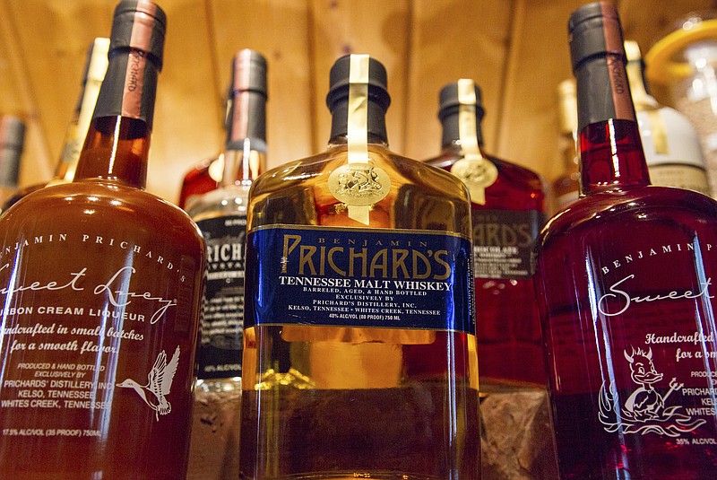 FILE - In this March 19, 2015 file photo, bottles of spirits are on display at the Prichard's Distillery in Nashville, Tenn. A spirits industry trade group says the tariff-induced hangover for American whiskey producers became more painful in late 2018. The Distilled Spirits Council said Thursday, March 20, 2019  that a downturn in American whiskey exports accelerated at the end of last year, especially in the European Union _ the industry’s biggest overseas market. (AP Photo/Erik Schelzig)