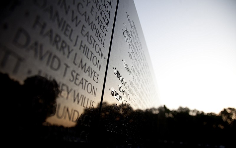 The Vietnam Veterans Memorial Wall is seen as the sun rises on Memorial Day 2012 in Washington, D.C. / AP File Photo/Carolyn Kaster