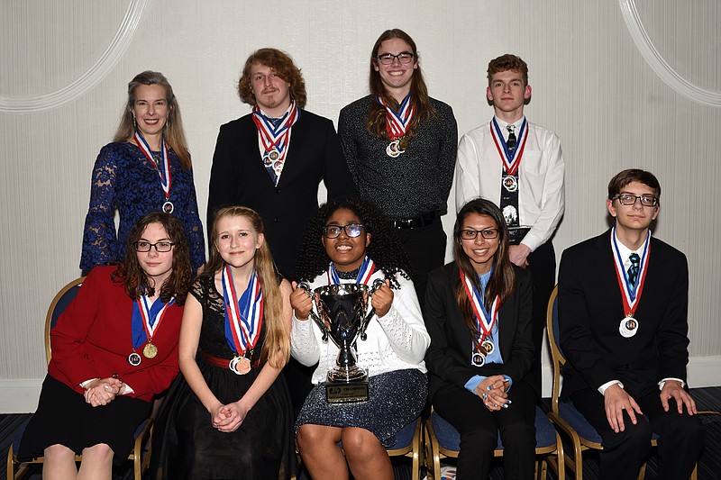 Lakeview-Fort Oglethorpe High School academic decathlon team members and coaches pose with a trophy from a "Superquiz" event at the 2019 PAGE Georgia Academic Decathlon State Competition. Front from left are Shannon Kinsey, Eden Muina, Jewel Okoronkwo, Shaili Patel and Ben Sprayberry. Back from left are coach Lisa Beck, Zach Carter, Daniel O'Steen and Jackson Lewis. (Contributed photo by Lisa Beck)