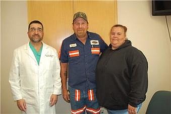 Dr. Navid Monajjem, left, with Jonathan and Melynda Lawson. Monajjem performed colon cancer surgery on Jonathan Lawson last June.
