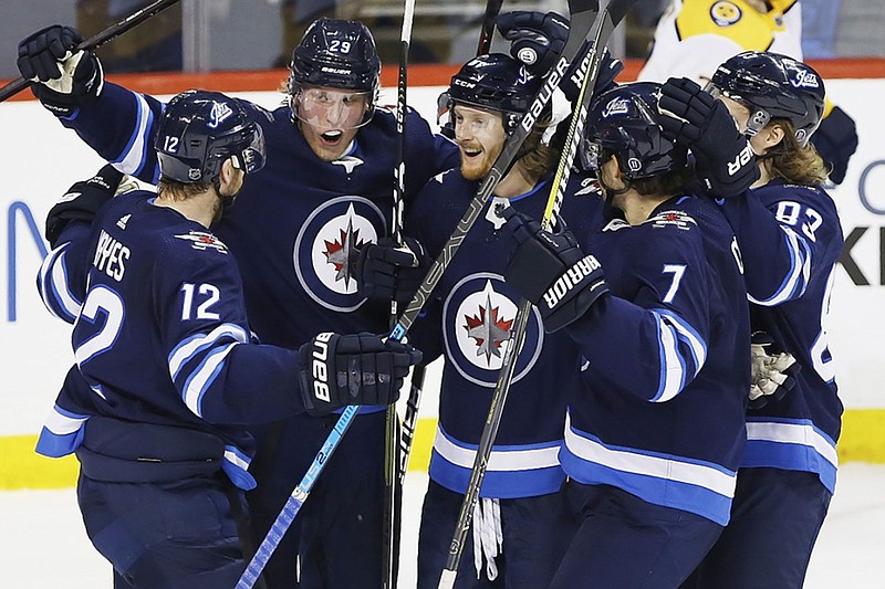From left, the Winnipeg Jets' Kevin Hayes, Patrik Laine, Kyle Connor, Ben Chiarot and Sami Niku celebrate Connor's second of three goals in Saturday night's game against the Nashville Predators in Winnipeg, Manitoba.