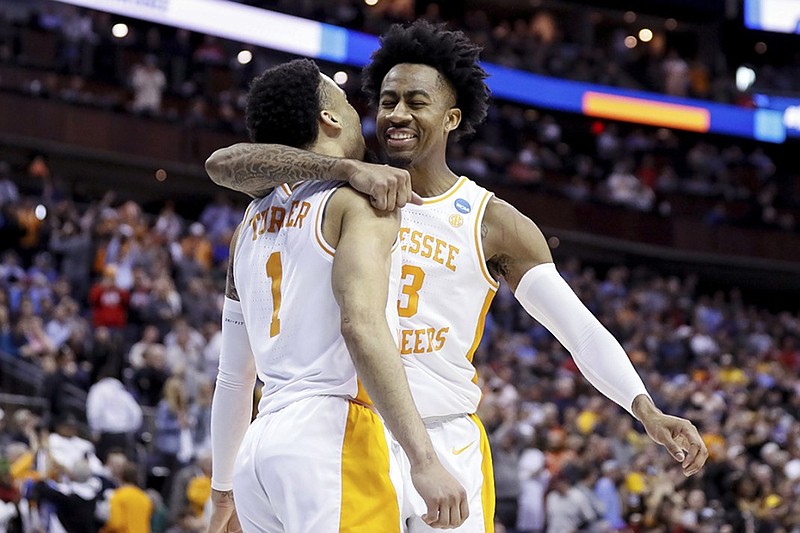 Tennessee's Jordan Bowden, right, and Lamonte Turner celebrate after the Vols beat Iowa 83-77 in overtime in an NCAA tournament second-round game Sunday in Columbus, Ohio.