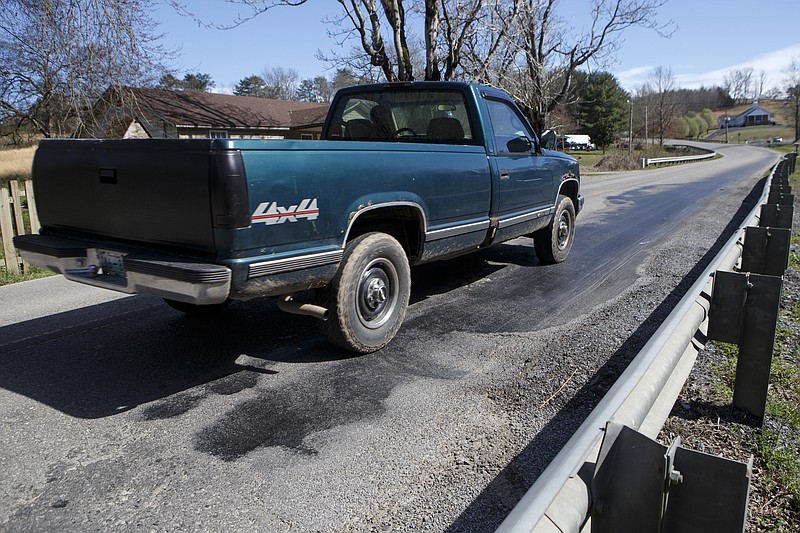 A pickup truck drivers over rutting in Smyrna Road on Friday, March 15, 2019 in Evensville, Tenn.