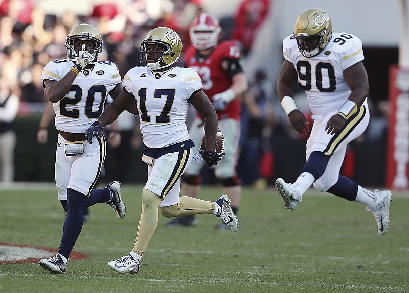 Georgia Tech's Lance Austin (17), Lawrence Austin (20) and Brandon Adams (90) celebrate an interception during the Yellow Jackets' game against rival Georgia in November 2016 in Athens. Adams has died at the age of 21. The school announced player's death Sunday.
