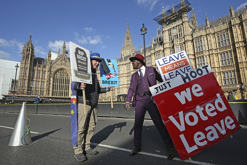 Protestors for opposing views face off against each other, with pro-Brexit split from Europe at right, and pro-Europe anti Brexit at left, outside parliament in London, Monday March 25, 2019. (Jonathan Brady/PA via AP)