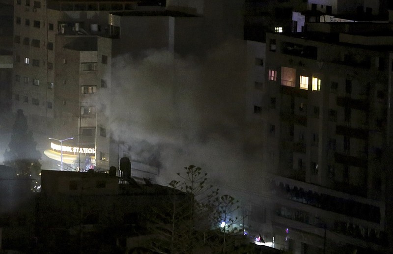 An explosion caused by Israeli airstrikes is seen from a Hamas-affiliated insurance company in Gaza City, Monday, March 25, 2019. Israeli forces on Monday struck targets across the Gaza Strip in response to a surprise rocket attack from the Palestinian territory, as the military beefed up troops and rocket-defense systems in anticipation of a new round of heavy fighting with the Islamic militant Hamas group. (AP Photo/Adel Hana)
