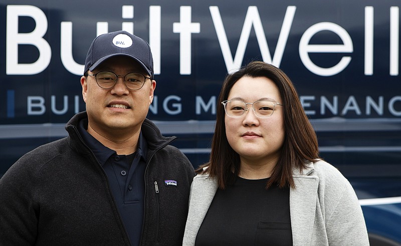 Jae, left, and Janie Yu pose in front of the BuiltWell van outside of a newly constructed home on Monday, March 4, 2019 in Ooltewah, Tenn.