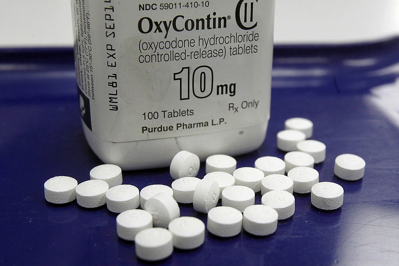 FILE - This Feb. 19, 2013, file photo shows OxyContin pills arranged for a photo at a pharmacy in Montpelier, Vt. Oklahoma's attorney general will announce a settlement Tuesday, March 26, 2019, with Purdue Pharma, one of the drug manufacturers named in a state lawsuit that accuses them of fueling the opioid epidemic. (AP Photo/Toby Talbot, File)