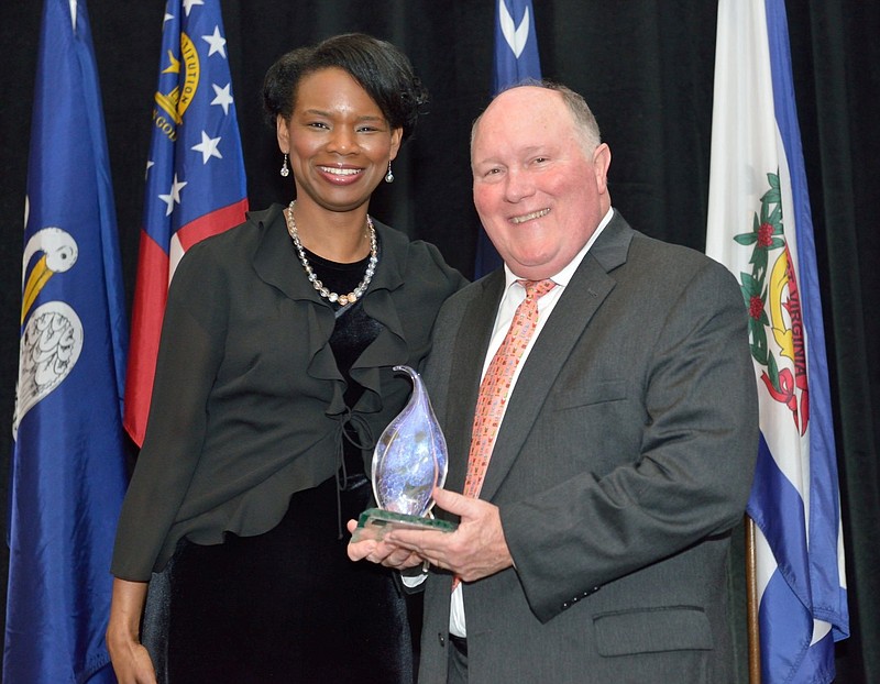 Southeast Tourism Society President Monica Smith presents award to Rock City Owner Bill Chapin. (Photo by Tony Giese)