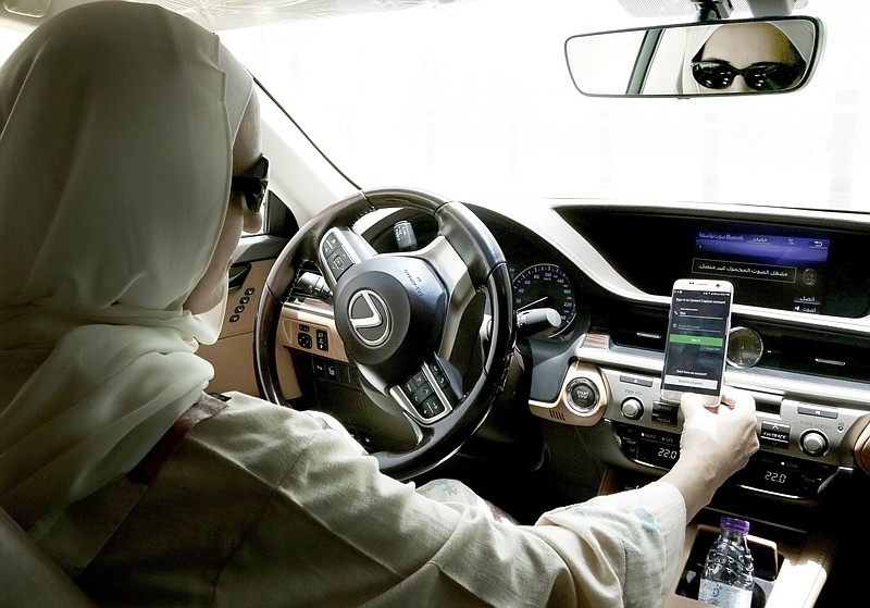 In this June 24, 2018 photo, Ammal Farahat, who has signed up to be a driver for Careem, a regional ride-hailing service that is a competitor to Uber, opens the Careem app on her mobile phone before she starts driving, in Riyadh, Saudi Arabia. Ride-hailing service Uber announced on Tuesday, March 26, 2019 it has acquired Mideast competitor Careem for $3.1 billion, giving the San Francisco-based firm the commanding edge in a region with a large young, tech-savvy population. (AP Photo/Nariman El-Mofty)