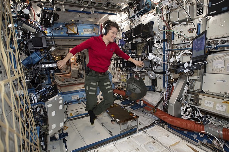 In this Jan. 18, 2019 photo made available by NASA, Flight Engineer Anne McClain looks at a laptop computer screen inside the U.S. Destiny laboratory module of the International Space Station. McClain was supposed to participate in a spacewalk Friday, March 29, 2019 with newly arrived Christina Koch. But McClain pulled herself from the lineup because there's not enough time to get two mediums suits ready. Koch will go out with a male crewmate. (NASA via AP)

