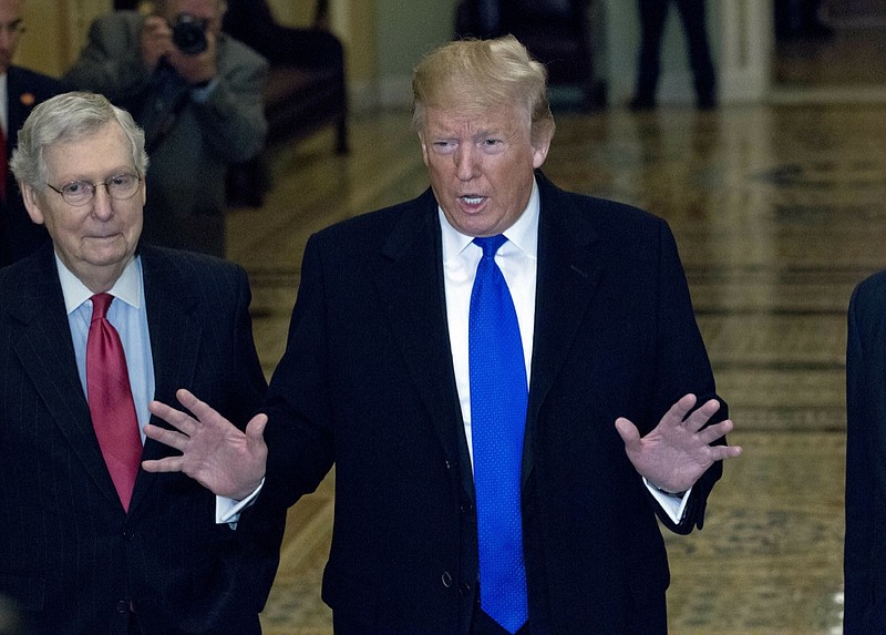 President Donald Trump accompanied by Senate Majority Leader Mitch McConnell of Ky., left, arrives for a Senate Republican policy lunch on Capitol Hill in Washington, Tuesday, March 26, 2019. (AP Photo/Jose Luis Magana)