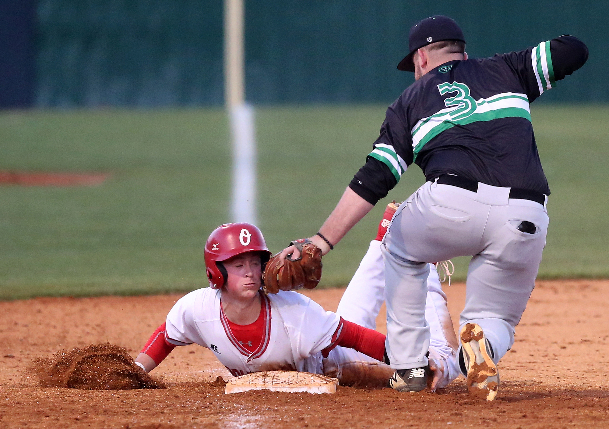 Ooltewah's Jacob Robinson (7) is tagged out by East Hamilton third baseman Noah Pridmore (3) Tuesday, March 26, 2019 during the East Hamilton vs. Ooltewah baseball game at Ooltewah High School in Ooltewah, Tennessee.