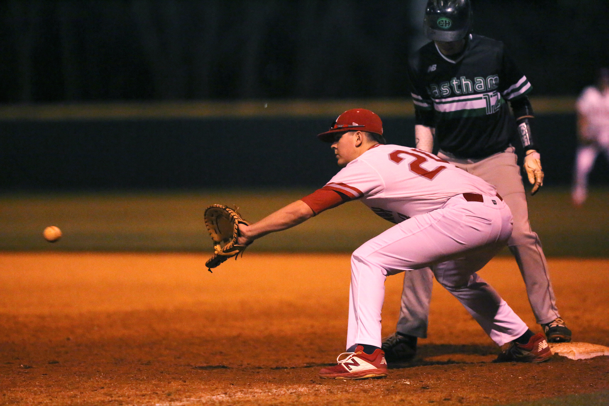 Ooltewah first baseman Colby Taylor (24) reaches out for a pickoff throw as East Hamilton's Blaine Savage (12) stands on the bag Tuesday, March 26, 2019 during the East Hamilton vs. Ooltewah baseball game at Ooltewah High School in Ooltewah, Tennessee.