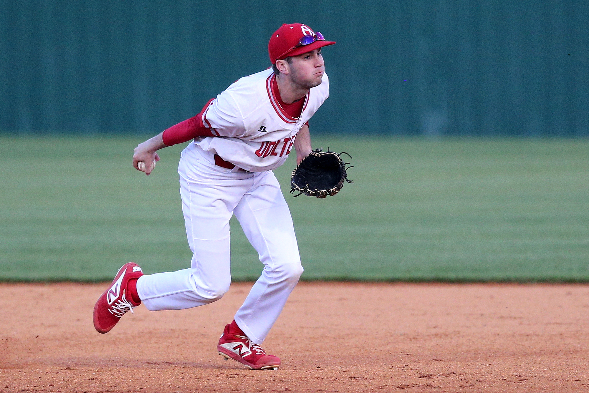 Ooltewah second baseman Trevor Dunlevy (14) looks to toss the ball to first after bobbling a grounder Tuesday, March 26, 2019 during the East Hamilton vs. Ooltewah baseball game at Ooltewah High School in Ooltewah, Tennessee.