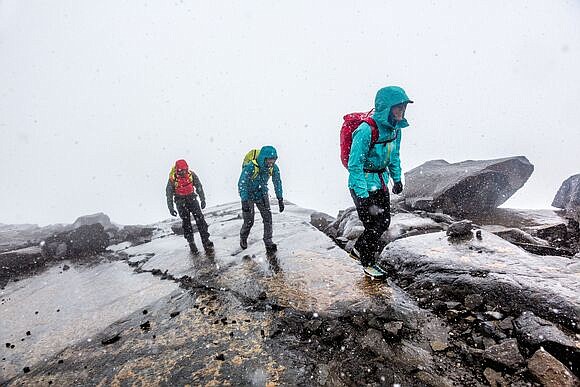 Hikers smile against the elements in their Patagonia Torrentshell rain jackets. / Photo by Mikey Schaefer