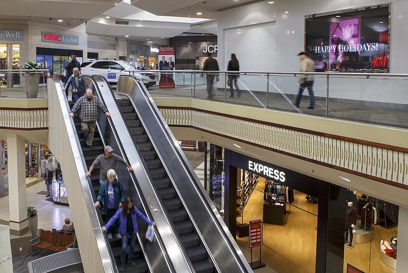 Staff file photo by C.B. Schmelter / People ride an escalator and move about at Hamilton Place mall late last year.