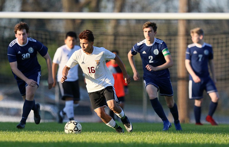 Howard's Neyder Gonzalez (16) pushes the ball downfield during the Howard vs. CSAS boys' soccer match Wednesday, March 27, 2019 at Chattanooga School for the Arts and Sciences in Chattanooga, Tennessee. CSAS won 2-1.
