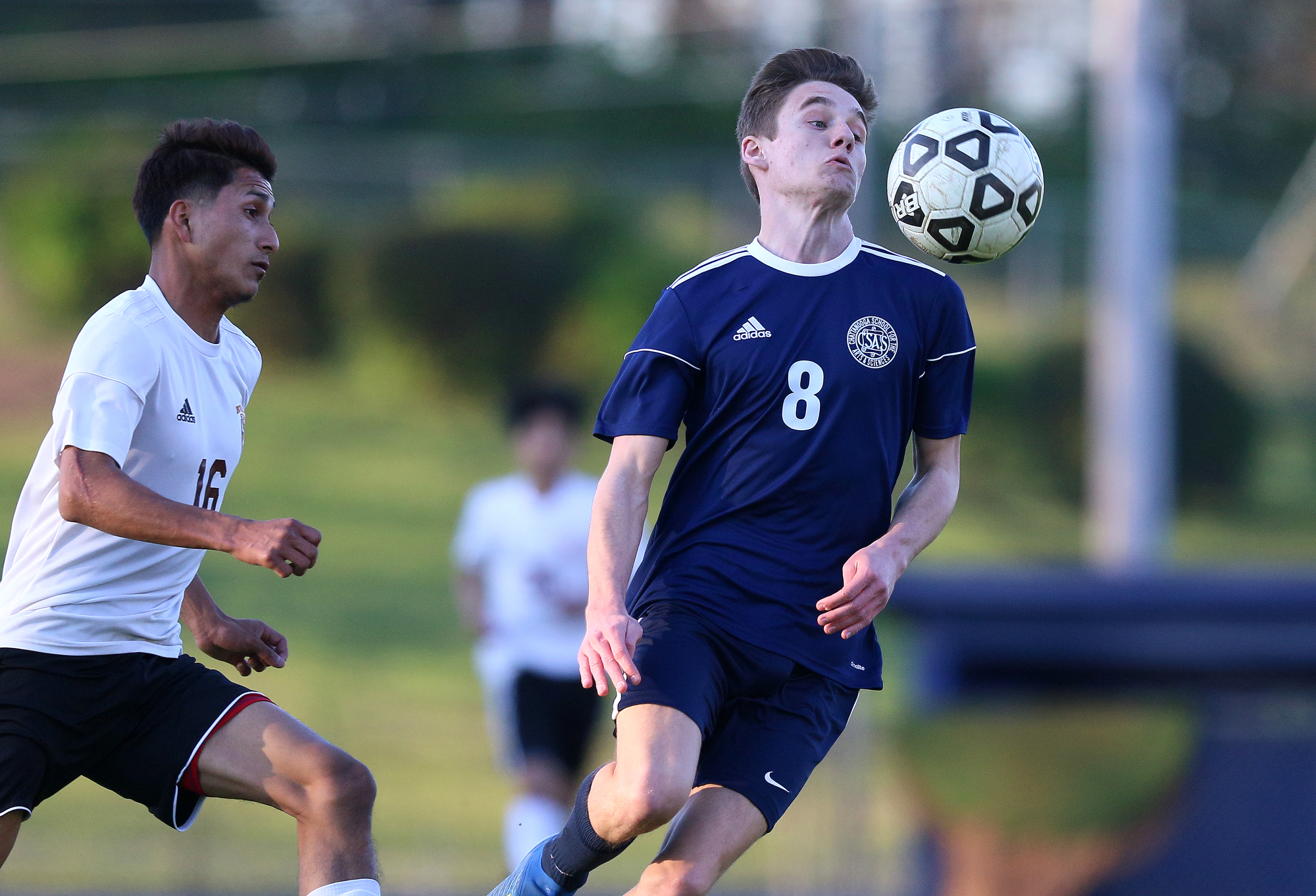 Howard's Neyder Gonzalez (16) goes after the ball as CSAS' Jackson Fields (8) settles the ball during the Howard vs. CSAS boys' soccer match Wednesday, March 27, 2019 at Chattanooga School for the Arts and Sciences in Chattanooga, Tennessee. CSAS won 2-1.
