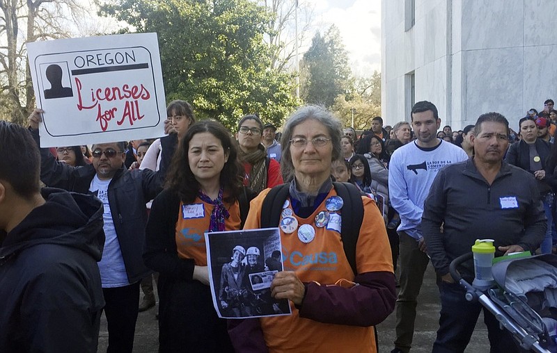 Immigrant rights advocates rally outside the Oregon state Capitol in favor of a measure that would expand driver's license access to undocumented immigrants Tuesday, March 26, 2019, in Salem, Ore. Oregon lawmakers are considering the change as it prepares to overhaul its state identification system in compliance with federal law. (AP Photo/Sarah Zimmerman)

