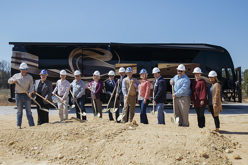 RV park owners and local leaders stand together during the groundbreaking ceremony for Hawkins Pointe on March 20. From left are Jim Wright, R. Wayne McCoy, Ross Andrews, Thad Hunt, Linda Smith, Jeff Bridgeman, Ty Edwards, park owners John and Karen Hawkins, Steven Henry, Jeff Long, Alicia Vaughn and Melissa Hannah. (Contributed photo by Ben Chase)