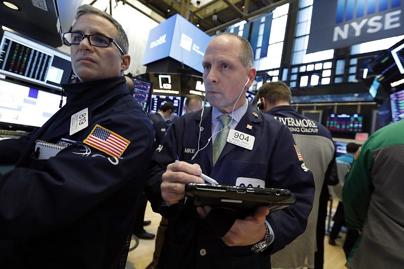 In this March 7, 2019, file photo specialist Anthony Rinaldi, left, and trader Michael Urkonis work on the floor of the New York Stock Exchange. The U.S. stock market opens at 9:30 a.m. EDT on Friday, March 29. (AP Photo/Richard Drew, File)