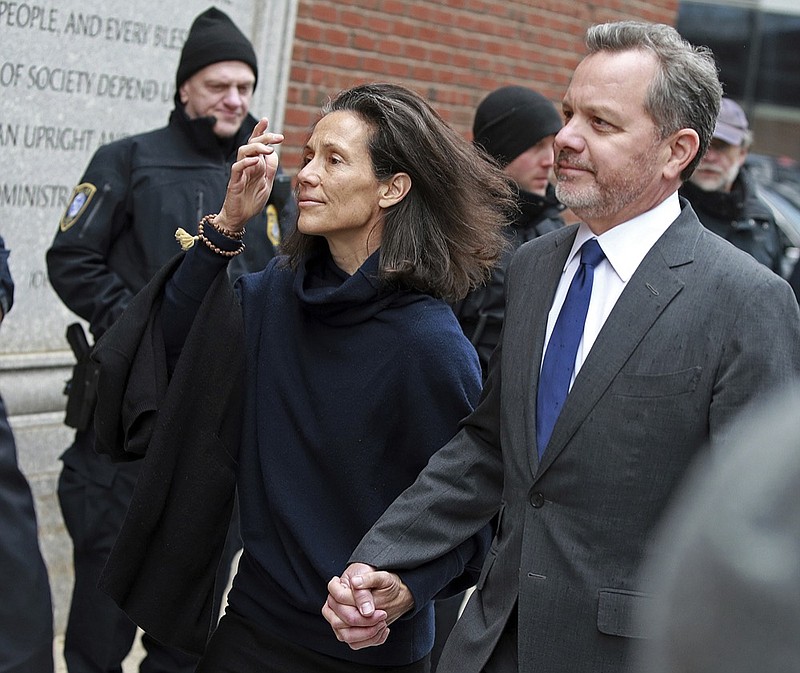 William McGlashan, 55, of Mill Valley, Calif., a senior executive at TPG private equity firm, arrives at the federal courthouse for a hearing associated with the college admissions bribery scandal, Friday, March 29, 2019 in Boston. McGlashan is accused of paying bribes to get his son into USC as a recruit for the college's storied football team, even though his son's high school didn't have a team. (Matt Stone/The Boston Herald via AP)

