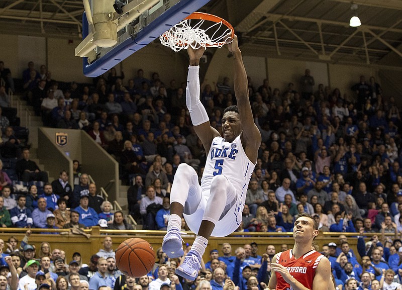FILE - In this Dec. 5, 2018, file photo, Duke's RJ Barrett (5) dunks against Hartford during the second half of an NCAA college basketball game, in Durham, N.C. Barrett was named to the AP All-ACC team, Tuesday, March 12, 2019. (AP Photo/Ben McKeown, File)