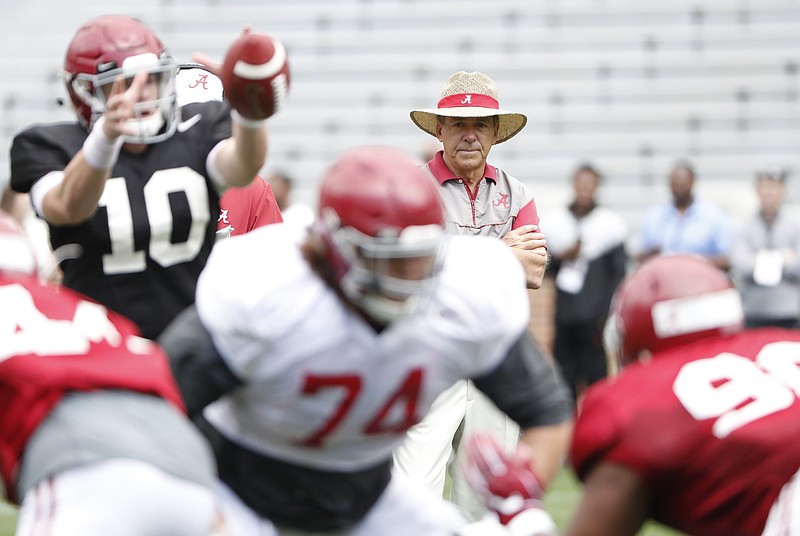 Alabama coach Nick Saban looks on as backup quarterback Mac Jones takes a snap during Saturday's scrimmage in Tuscaloosa.