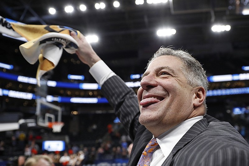 Auburn men's basketball coach Bruce Pearl celebrates the Tigers' win over Kansas in the second round of the NCAA tournament on March 23 in Salt Lake City.