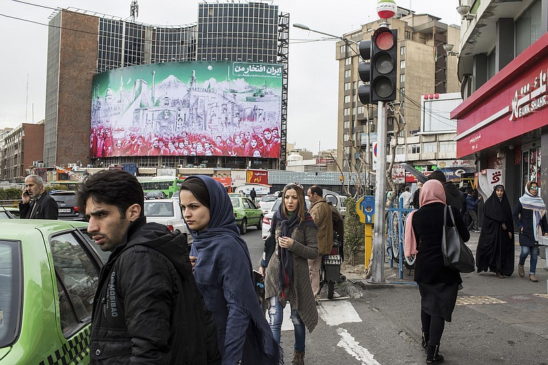 Iran's financial crisis, exacerbated by American sanctions, appears to be undermining its support for militant groups and political allies who boost Iranian influence in Iraq, Syria, Lebanon and elsewhere. In this file photo, a mural for the 40th anniversary of the Islamic revolution is installed in Valiasr Square in Tehran, Iran, last month. (Arash Khamooshi/The New York Times)