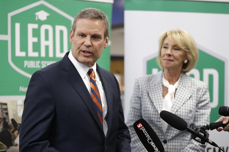 Tennessee Gov. Bill Lee and U.S. Education Secretary Betsy DeVos talk with reporters during a visit to Cameron Middle School Monday, April 1, 2019, in Nashville, Tenn. DeVos said she's encouraged by Tennessee's latest push to expand school vouchers throughout the state and said she's cheering on lawmakers to make the right choice. (AP Photo/Mark Humphrey)