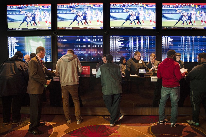 FILE - In this Dec. 13, 2018, file photo, gamblers place bets in the temporary sports betting area at the SugarHouse Casino in Philadelphia. Most of the states that moved quickly to legalize sports after a Supreme Court decision last year, including Pennsylvania, are still waiting for the expected payoff. (AP Photo/Matt Rourke, File)